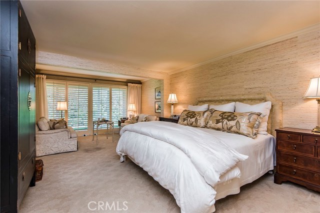 The master suite is positively stunning and generous in size. Designer carpet, grass cloth wall coverings, crown molding, his and hers walk-in closets and relaxing sitting area with French doors to a private patio. Warm, rich wood built-ins provide sophisticated storage in both the bedroom and exquisite master bathroom.