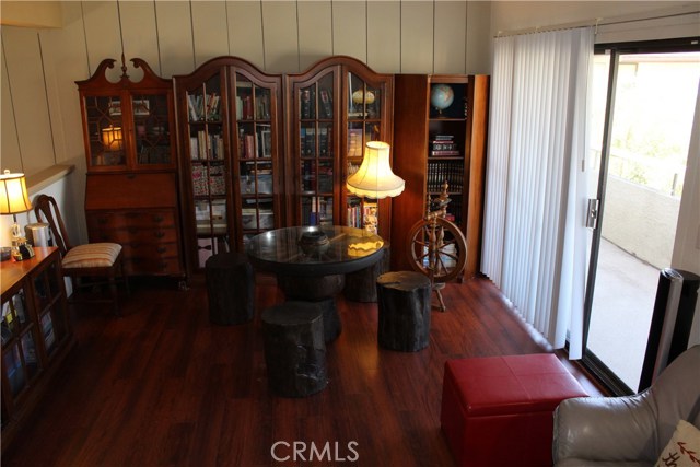 Upstairs  den area with sliding glass door to the right which leads out to the private walkway