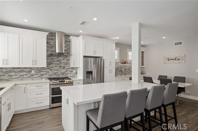 island includes a countertop bar with plenty of seating and extra storage island includes a countertop bar with plenty of seating and extra storage