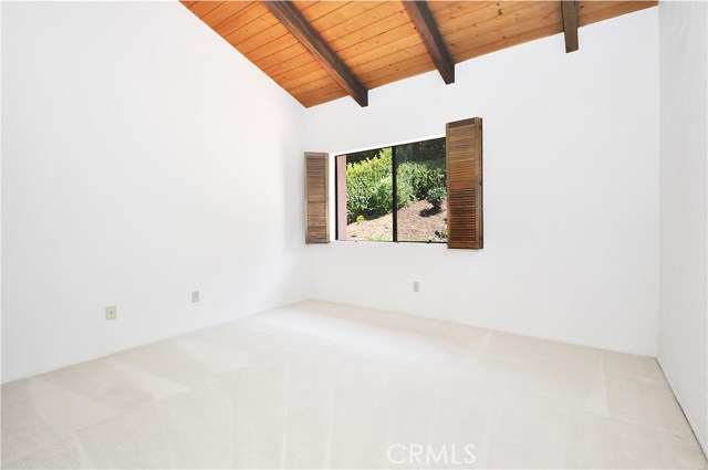 Bedroom 4 with backyard view and vaulted ceilings