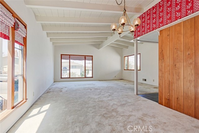 Living room and dining areas with the picture window facing north and dining room windows west.
