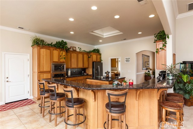 View of kitchen with eating bar and door leading out to the garages.