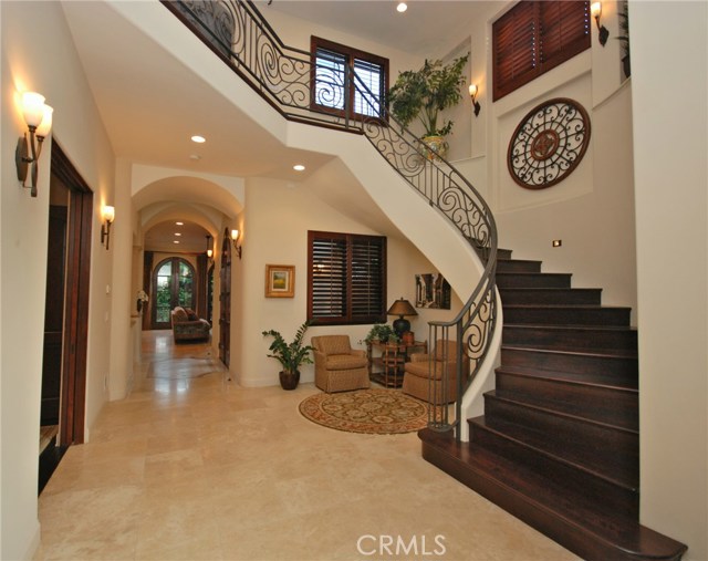 Curved walnut staircase and wrought iron railing