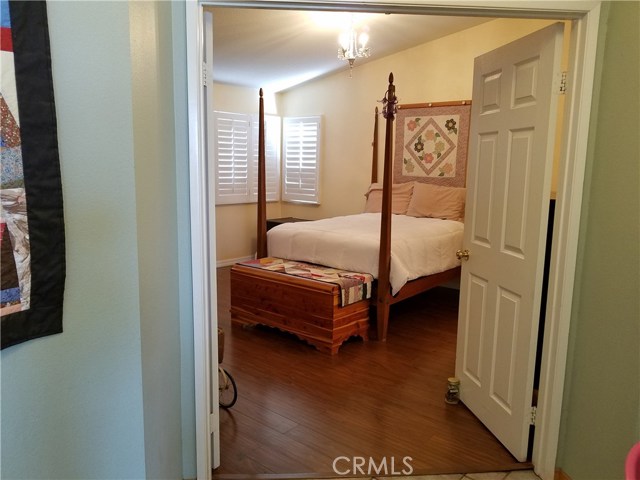 Double Door Entry To Master Bedroom With Wood Laminate Flooring.