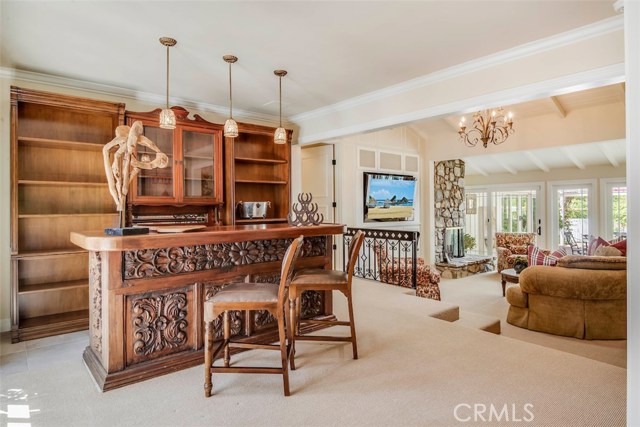 Custom antique built in wet bar with refrigerator, sink and ice maker.