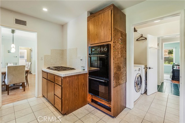 Kitchen is adjacent to the laundry room and has access to the exterior side yard