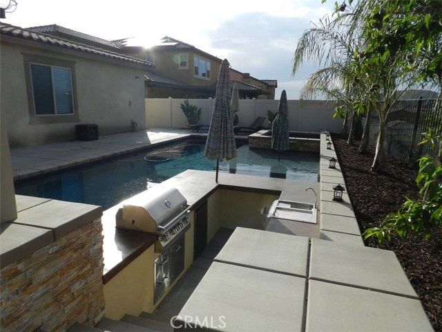 OUTDOOR KITCHEN WITH BBQ, SINK, FRIG, ETC.