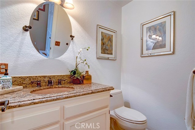 Downstairs powder room with granite counters for guests.