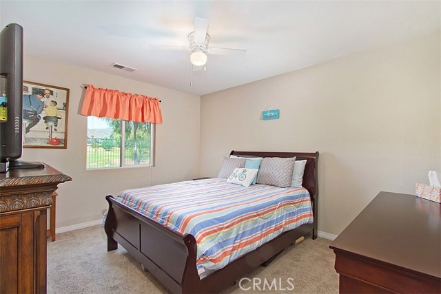 Large main floor bedroom with golf course vies, ceiling fan and bathroom w shower just outside the door.