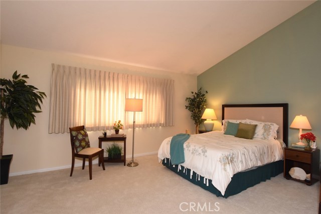 Large, private master suite has soaring ceilings, and walk in closet.