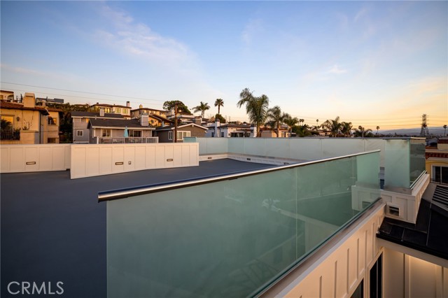 Frosted glass on roof top deck captures the sunsets and brilliantly radiates the glow across the deck