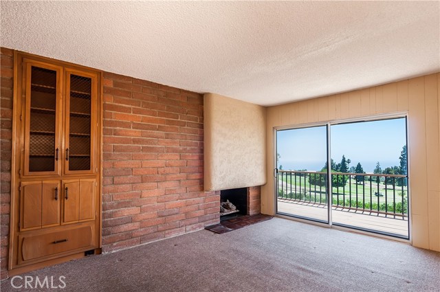 Study with fireplace, built-ins and view.