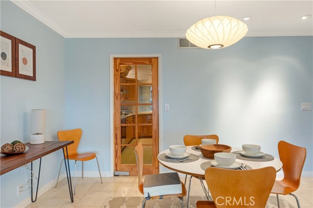 Swinging French door separates (or connects) the kitchen and dining room.