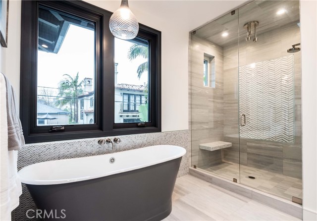 Master Bath with Custom Tile throughout with Glass Tile Accent. Stand Alone, High Quality Bathtub. 5.5’ x 3.5’ Enclosed Custom Tiled Shower with Steam, High Quality Kohler Shower Fixtures and Floating Bench.