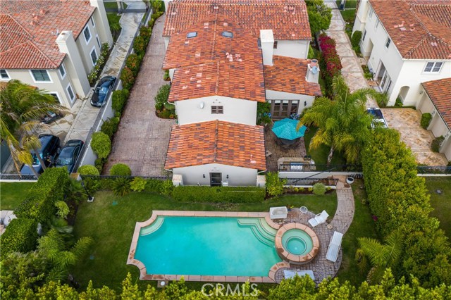 Aerial view from the back of the home.  Grassy back yard by umbrella wraps around the house to include the front yard!  Perfect for kids and pets!