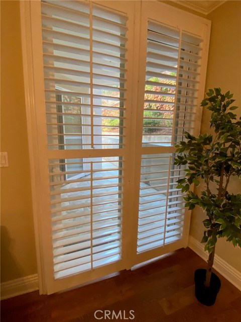 Sliding Glass Door with Plantation Shutters. Leads out to Back yard.