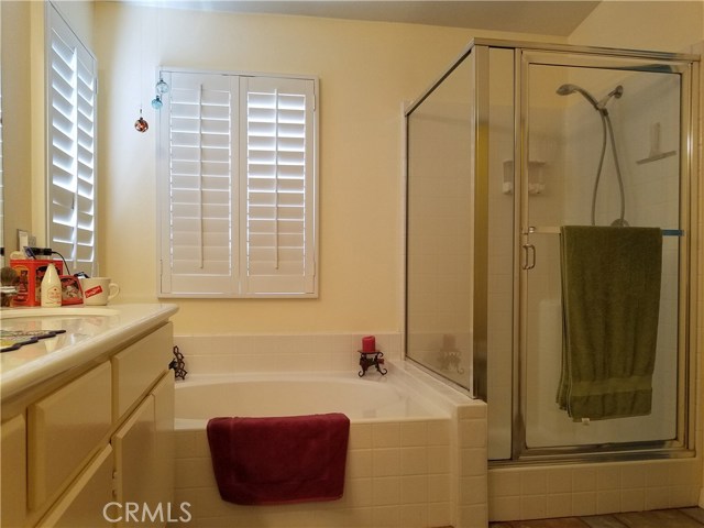 Master Bathroom Equipped With Separate Tub And Shower.