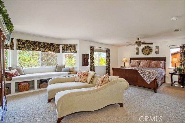 A spacious Master Suite large enough to fit a King Size Bed, two Lounge Chairs an Dressers. Note the window seat with storage area. Views of the golf course from every window.