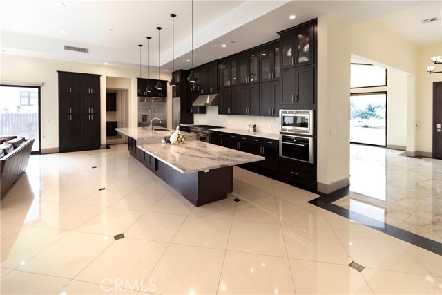 Huge Gourmet Kitchen w/center island and adjoining breakfast bar opens to Great Room (to the left)