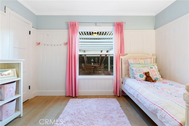Bedroom #2 - With a view into the playfiul backyard, custom wainscoting, Emtek oil rubbed bronze hinges and door knobs, lighting by Rejuvenation, Wide plank French oak flooring, Lutron dimmer light switches.