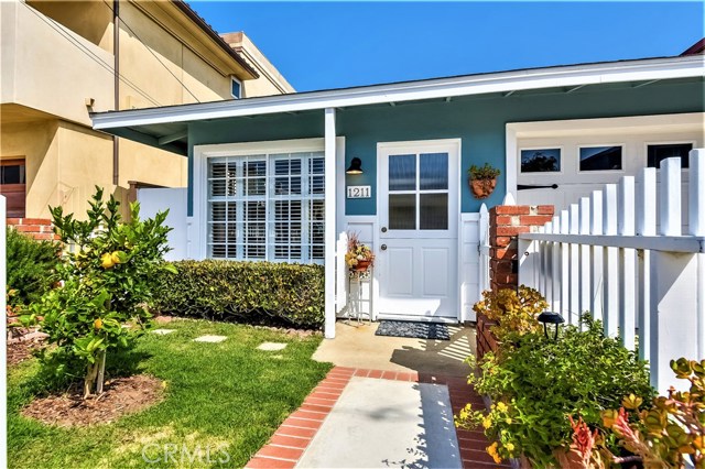 The gated entry leads down a brick lined walk to the front Dutch door