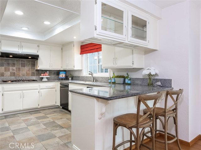 Kitchen with granite counters, recessed lighting and tile flooring