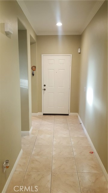 Hallway to the front door with nice recessed lighting