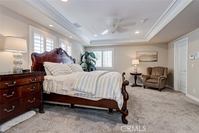 Master suite with plantation shutters and walk in closet