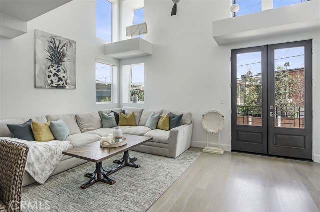 2nd Floor Living Room - High Ceiling with a Fan, Access to the Balcony