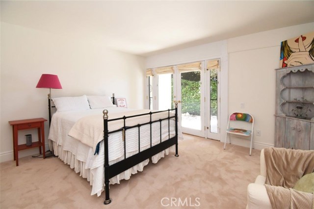 2nd bedroom with French doors open to the side yard