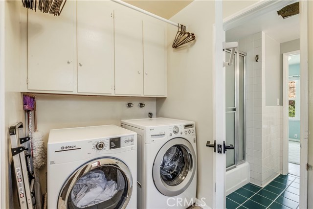 The laundry is spacious in size and features built-in cabinets for storage and access to the side yard