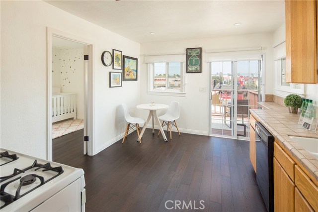 Upgraded kitchen with eating area looking out to deck through sliding glass doors.