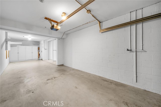 Garage with room for all those toys and faucet for washing off sand.