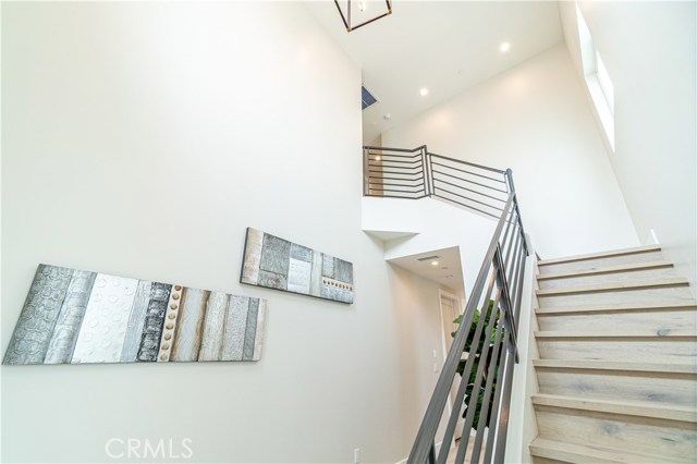 Staircase going up. High Ceilings & Chandelier.