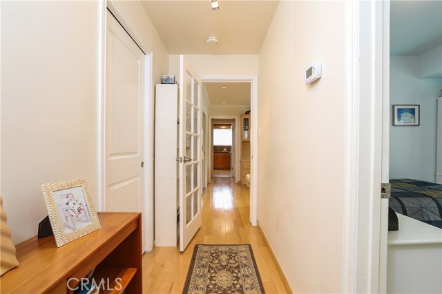 Hallway leading to two bedrooms and walk in closet