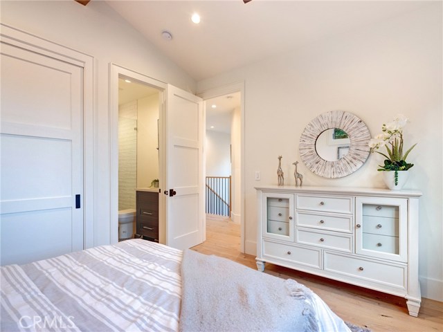 Upstairs bedroom suite #3, with bench, Trestlewood reclaimed wood accent beam and en-suite bathroom.