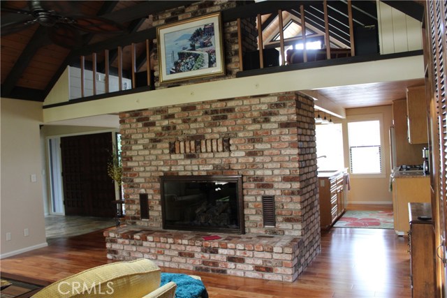 from living room and wet bar toward kitchen and entry area, notice usable loft area above