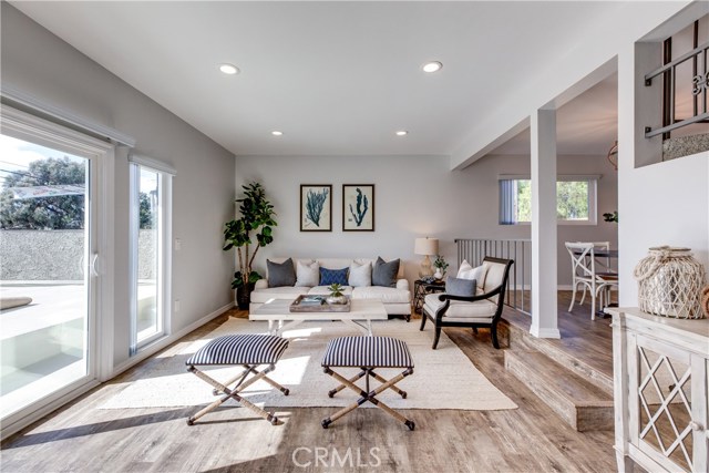 Enter the living room, filled with natural light which is spacious enough to entertain and features sliding glass doors that lead to a large patio that over looks the park