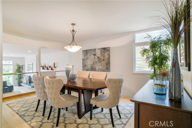 Dining room overlooks living room.  Pretty greenery views from back windows!