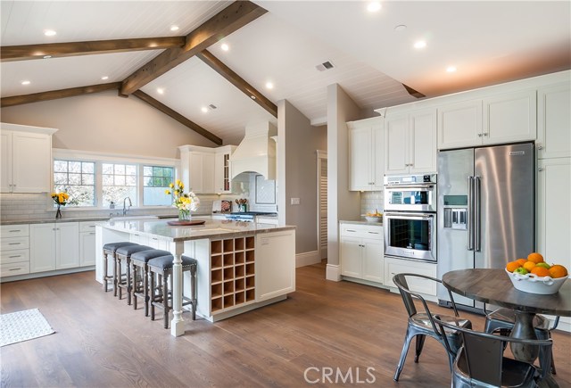 Gorgeous custom kitchen overlooking backyard and sliding doors leading to outdoor entertaining space