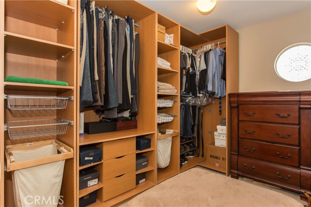 Substantial Master Closet with Built In Cupboards and Stain Glass Window