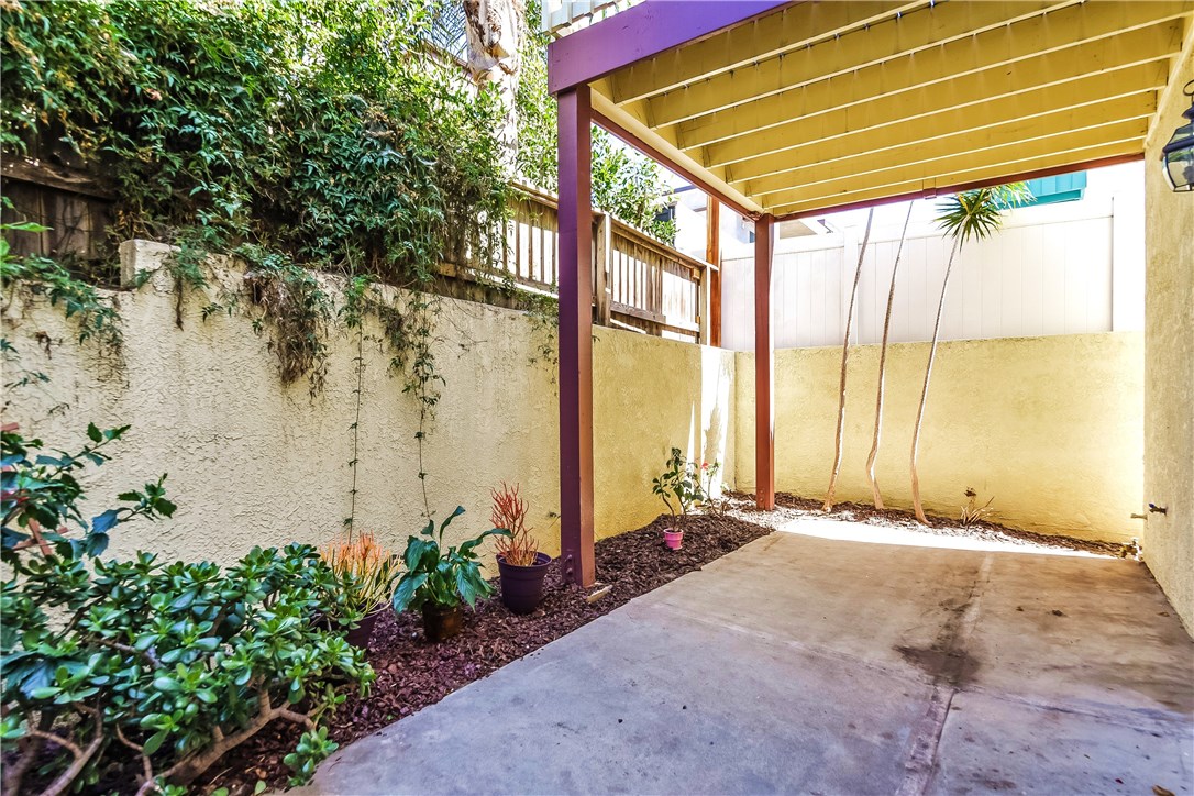 The rear yard is private and planted with lush landscaping.  The upper level deck, overhead off of the rear second story of the house offers an additional sense of privacy.