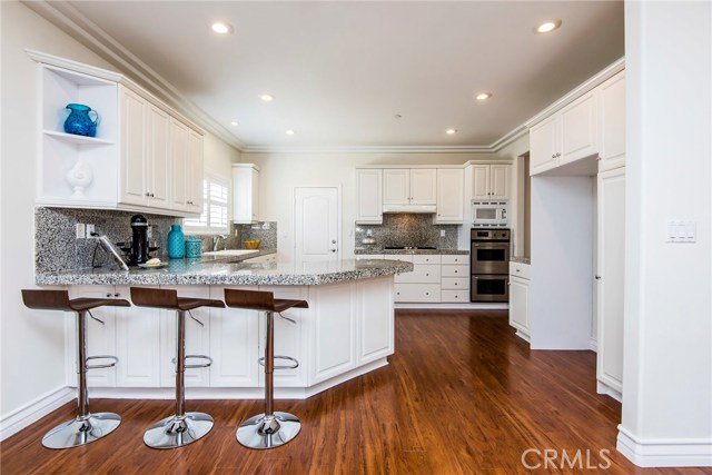 Kitchen breakfast bar seats 4 or more.  Chef's kitchen with stainless steel double ovens, 5 burner built-in gas range, Miele dishwasher and built-in microwave.