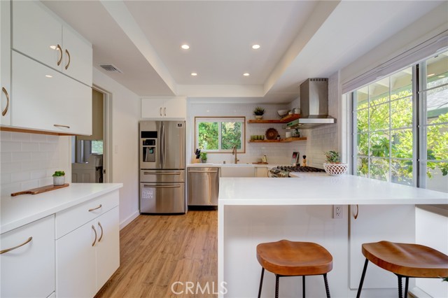 Updated kitchen with breakfast counter and stainless steel appliances