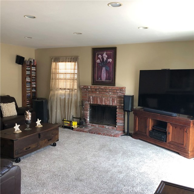 Huge family room with a fireplace & sliding door to the back yard patio.