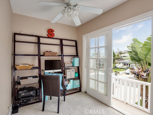 Upstairs office area can also be used as a reading nook or arts/crafts area.  French slider doors lead to large deck above garage.