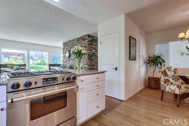 kitchen has a large eat in area with an abundance of storage cabinets against the wall