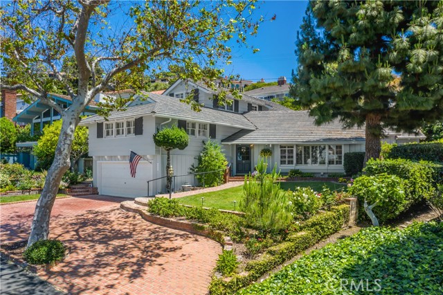 A lush and tranquil landscape surrounds as you admire the tall trees, winding roads, and ocean views that set the path to this custom-built ranch style home on Espinosa Circle.