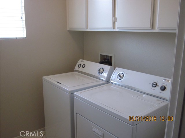 Laundry room, washer and dryer to stay for new buyer.