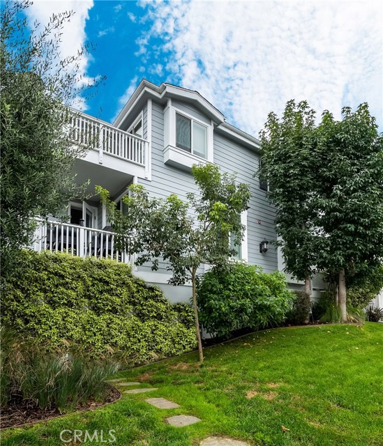 Recently repainted Cape Cod exterior with rolling lawn.